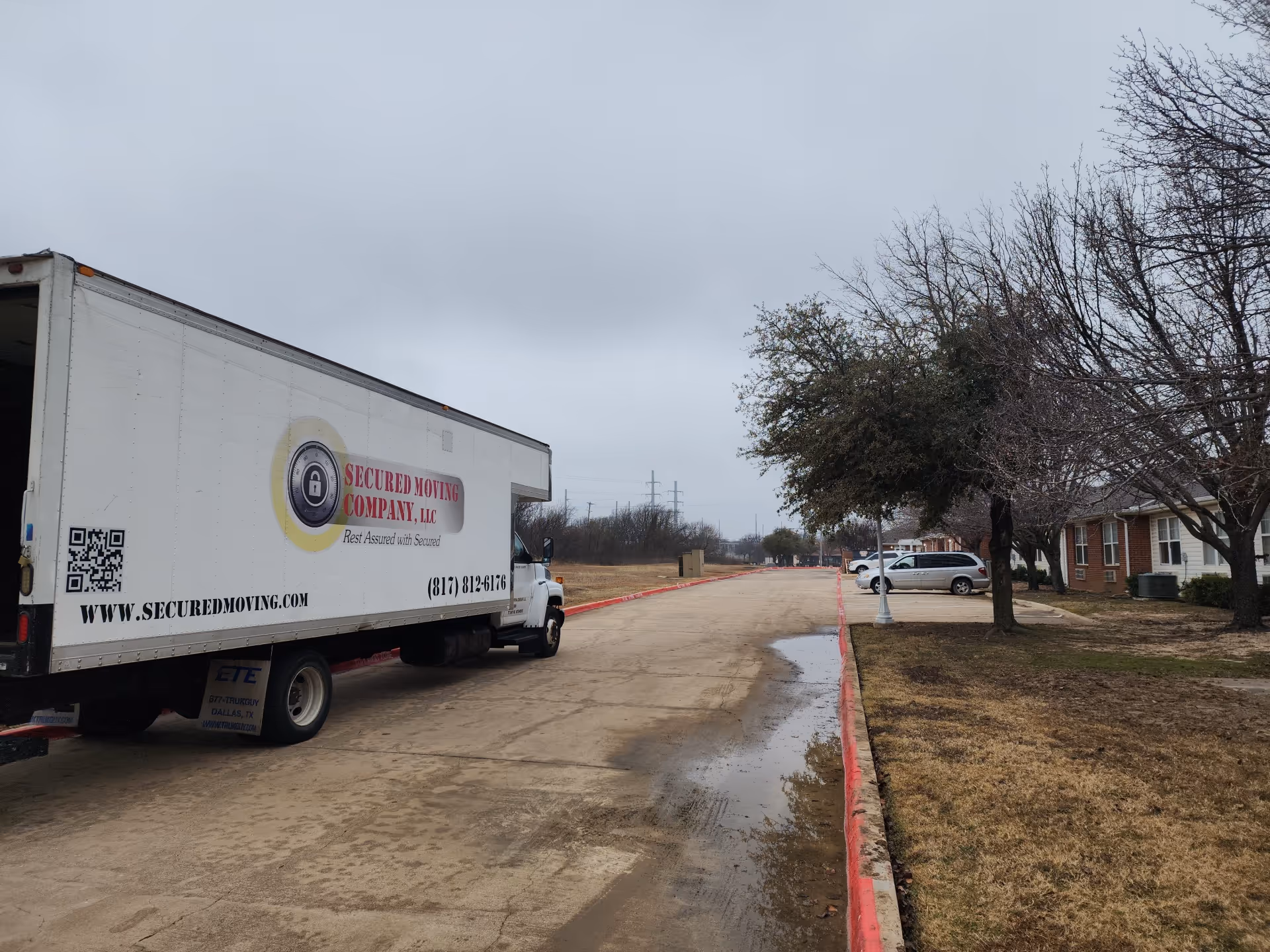 White moving truck parked outside Whitley Place senior living facility.
