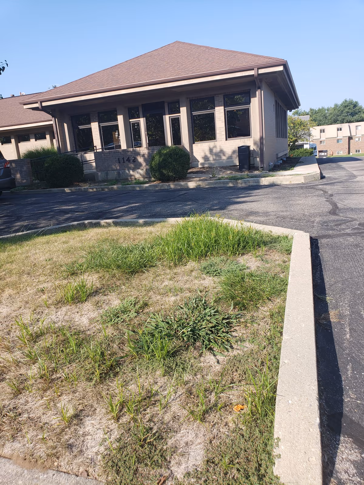 Exterior view of Greenville Nursing Services Inc. building with soft landscaping and a parking lot.