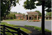 Exterior view of Future Care Chesapeake facility showcasing entrance, parking, and landscaped surroundings.