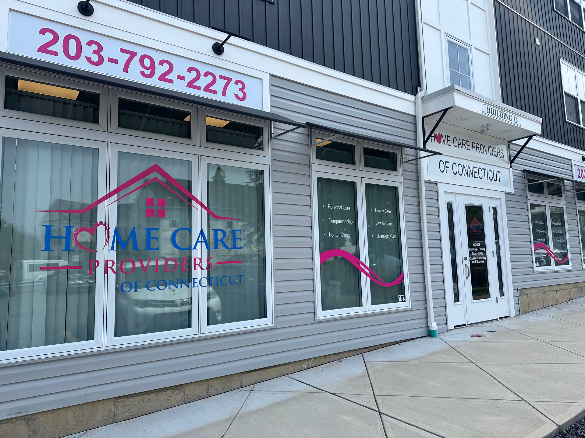 Exterior view of Home Care Providers of Connecticut storefront with large logo windows.