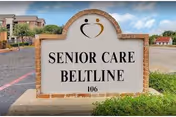Exterior view of the Senior Care Beltline sign with a brick frame and building behind.