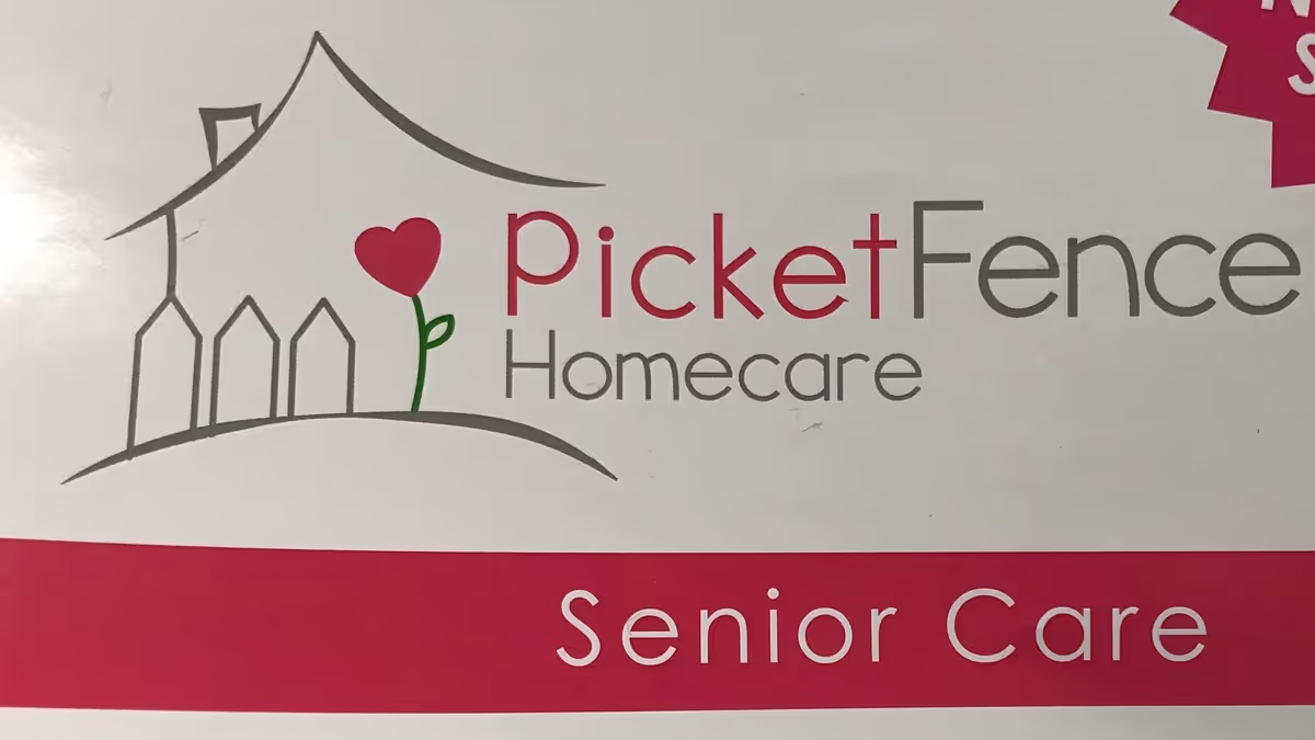 Logo for PicketFence Homecare Senior Care featuring a house outline and heart-shaped flower.
