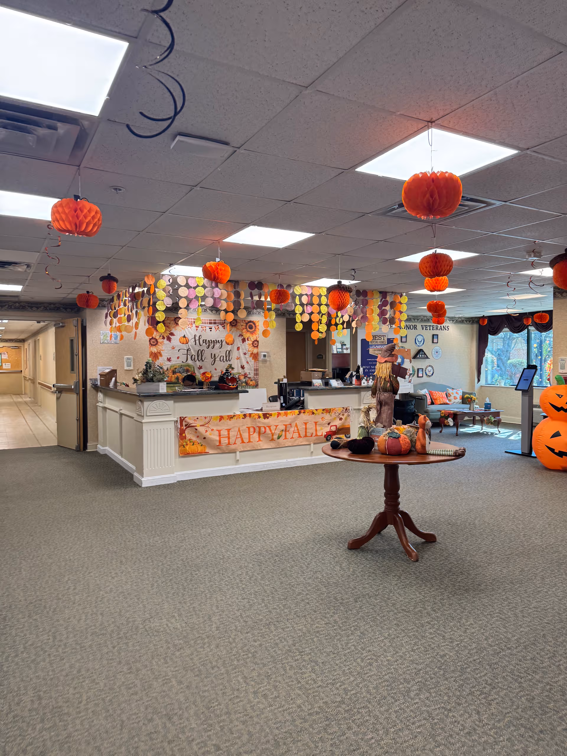 Lobby of Complete Care at Park Place decorated for autumn with banners, pumpkins, garlands.