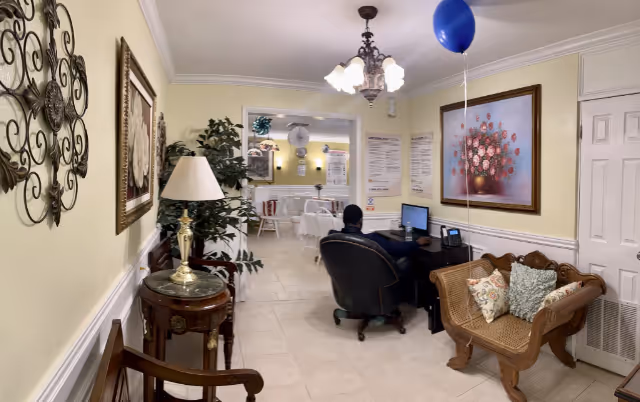 Reception area of St Lukes Sunrise Care Center with a receptionist at a computer.