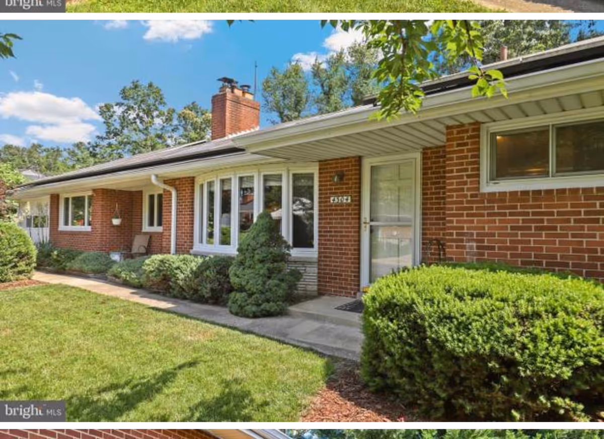Brick, single-story assisted living building with front entrance, shrubs, and a green lawn.