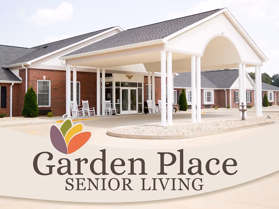 Entrance of a brick senior living facility with a covered porte-cochère, white columns, rocking chairs, and an overlaid Garden Place Senior Living logo.