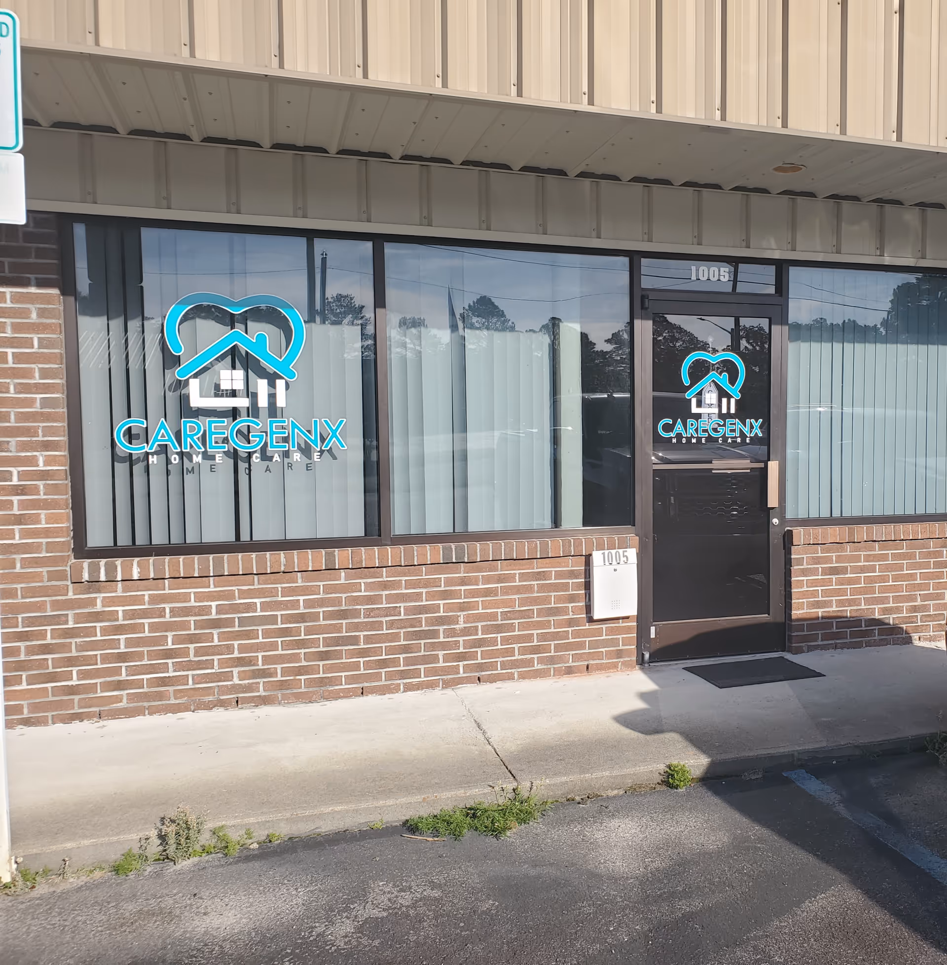 Exterior view of Caregenx Home Care storefront with blue logo on windows