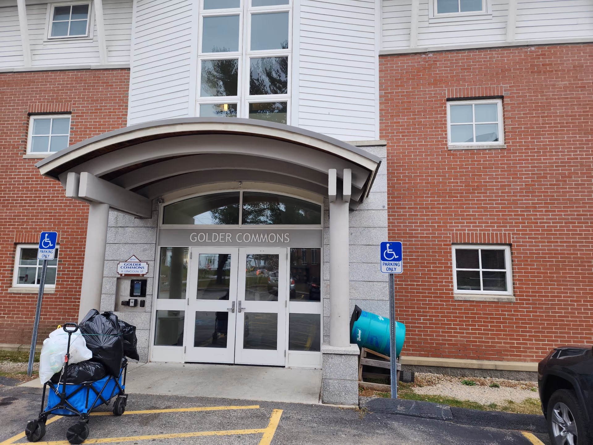 Exterior view of the building entrance labeled GOLDER COMMONS with a curved canopy.