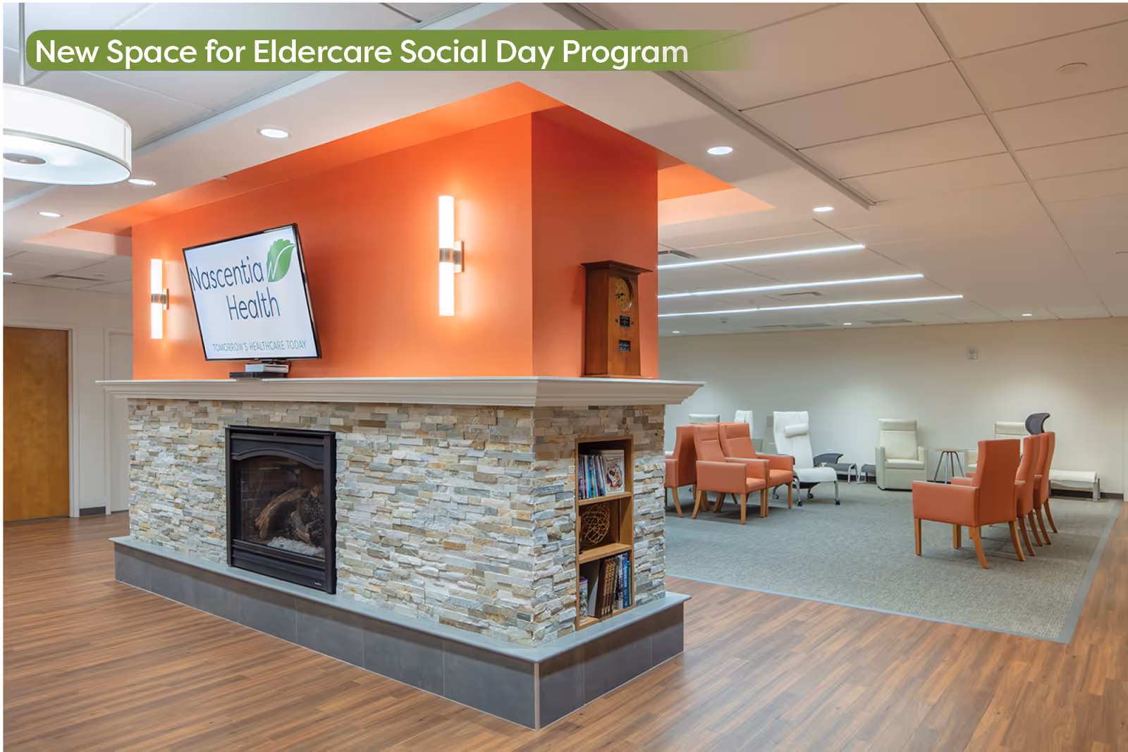 Modern senior living lobby with fireplace, stone facade, orange accent wall, and comfortable seating.