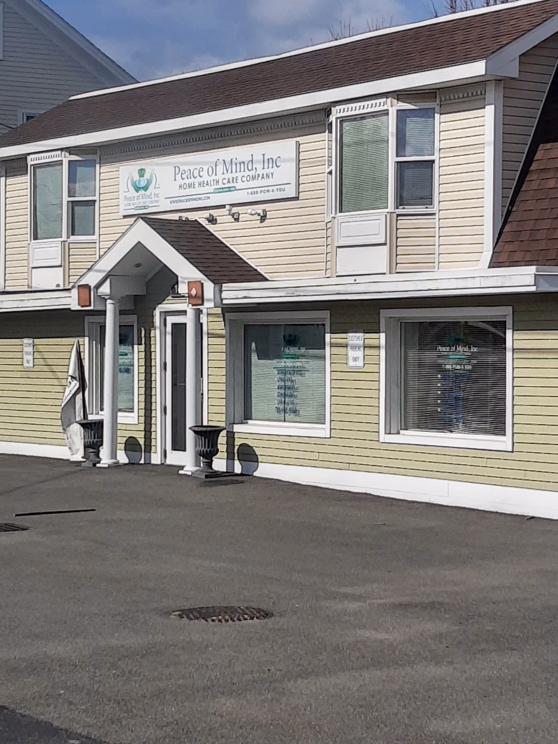 Exterior view of Peace of Mind Home Health Care building with sign.