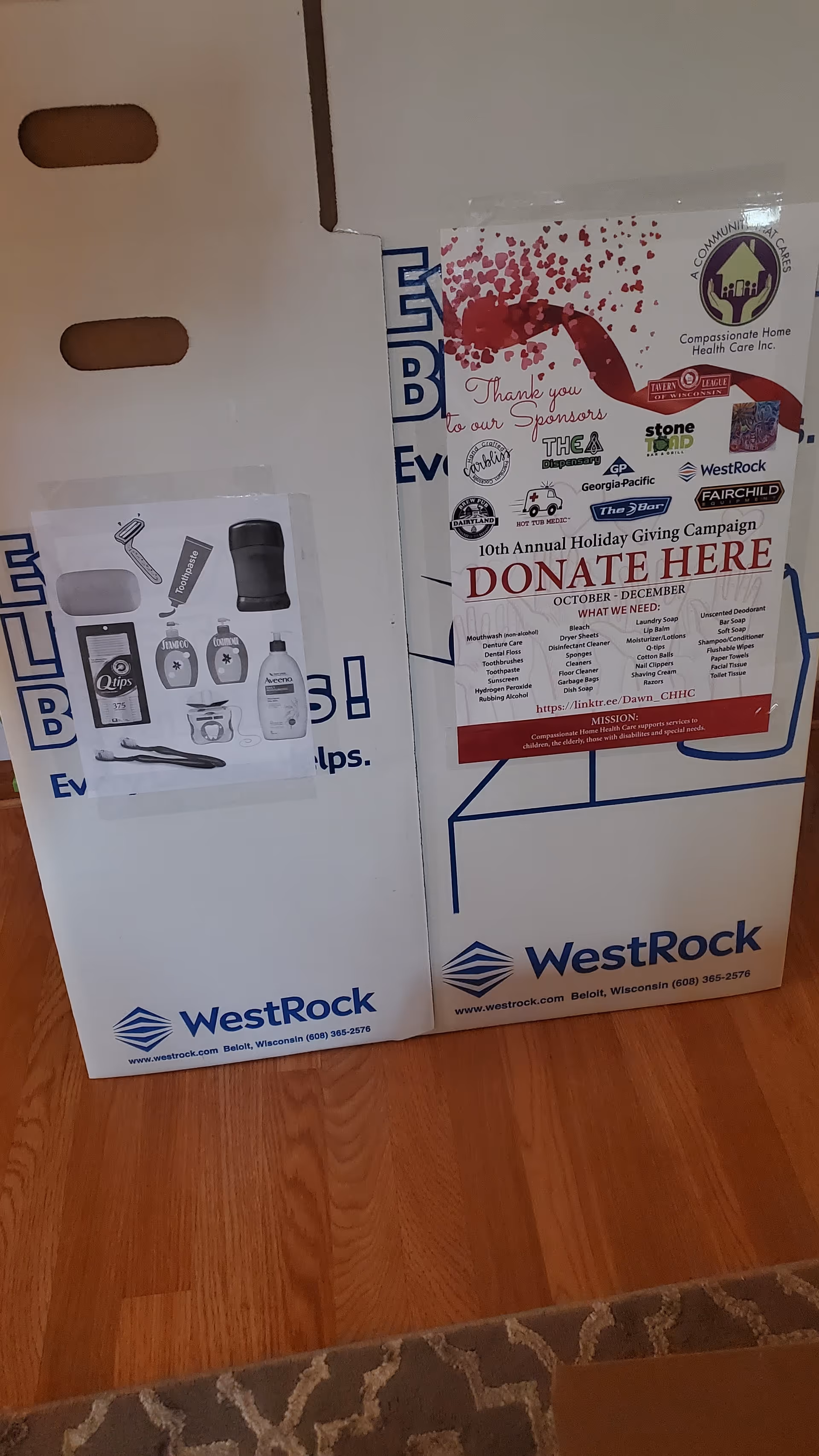 Indoor scene with donation posters displayed on large boxes inside the facility.