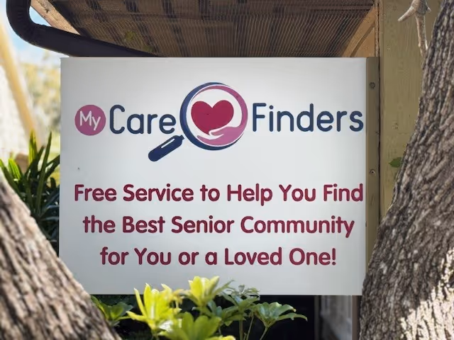 Exterior sign displays My Care Finders logo and message about finding senior communities outside.