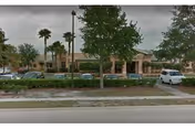 Exterior view of Atlantic Shores Nursing and Rehab Center with cars parked in front.