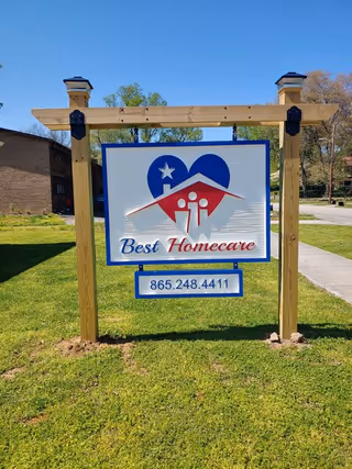 Front sign for Best Homecare LLC on a grassy lawn beside a sidewalk.