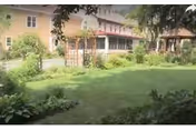 Outdoor view of Holton Memorial Home with a grassy lawn and building facade.