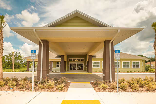 Front entrance of Scott Lake Health and Rehabilitation with a covered walkway and handicap parking signs.