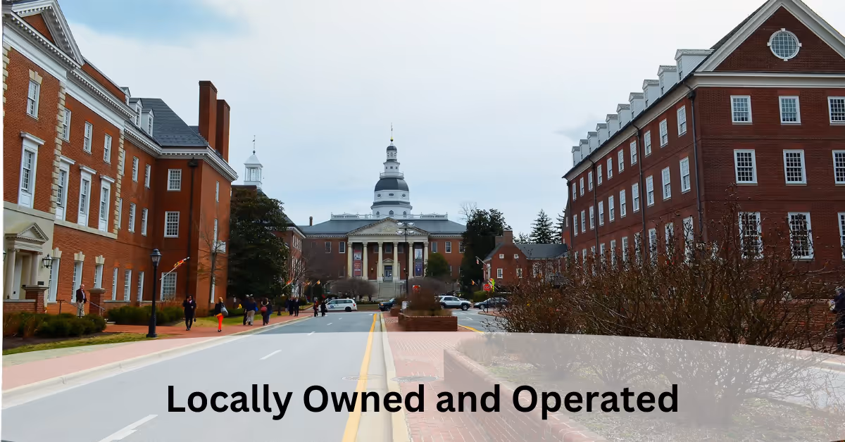 Brick campus buildings frame a domed central building along a tree-lined street.