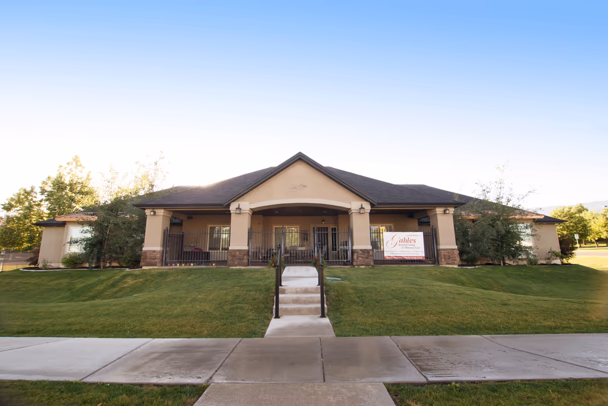 Front view of a single-story assisted living building with a manicured lawn and entrance.