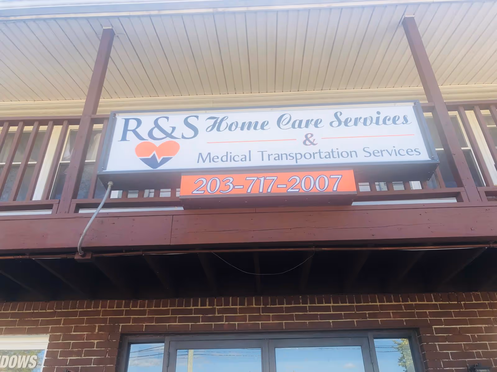 Exterior signboard reading R&S Home Care Services and Medical Transportation Services.