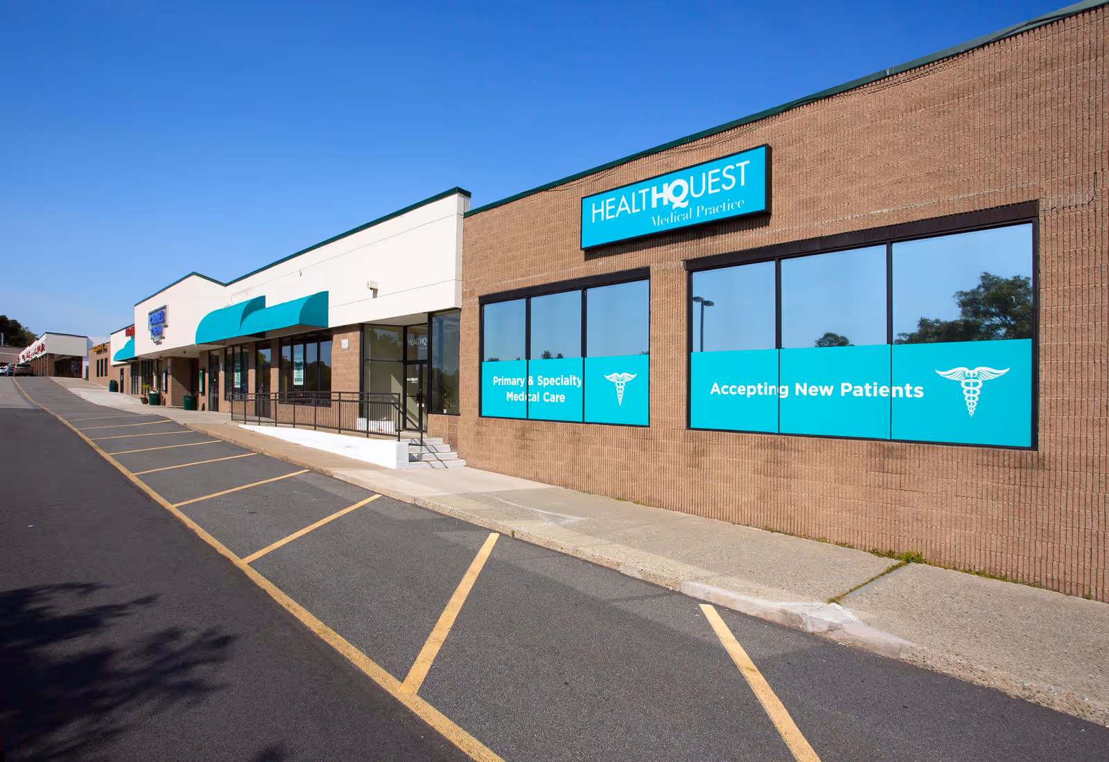 Exterior view of Health Quest Medical Practice storefronts with teal signage.