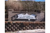 A brick entrance wall with a Princeton Health Care Center sign and landscaping.