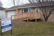 Single-story beige facility with a wooden ramp leading to the entrance, Bethany House Sioux Falls.