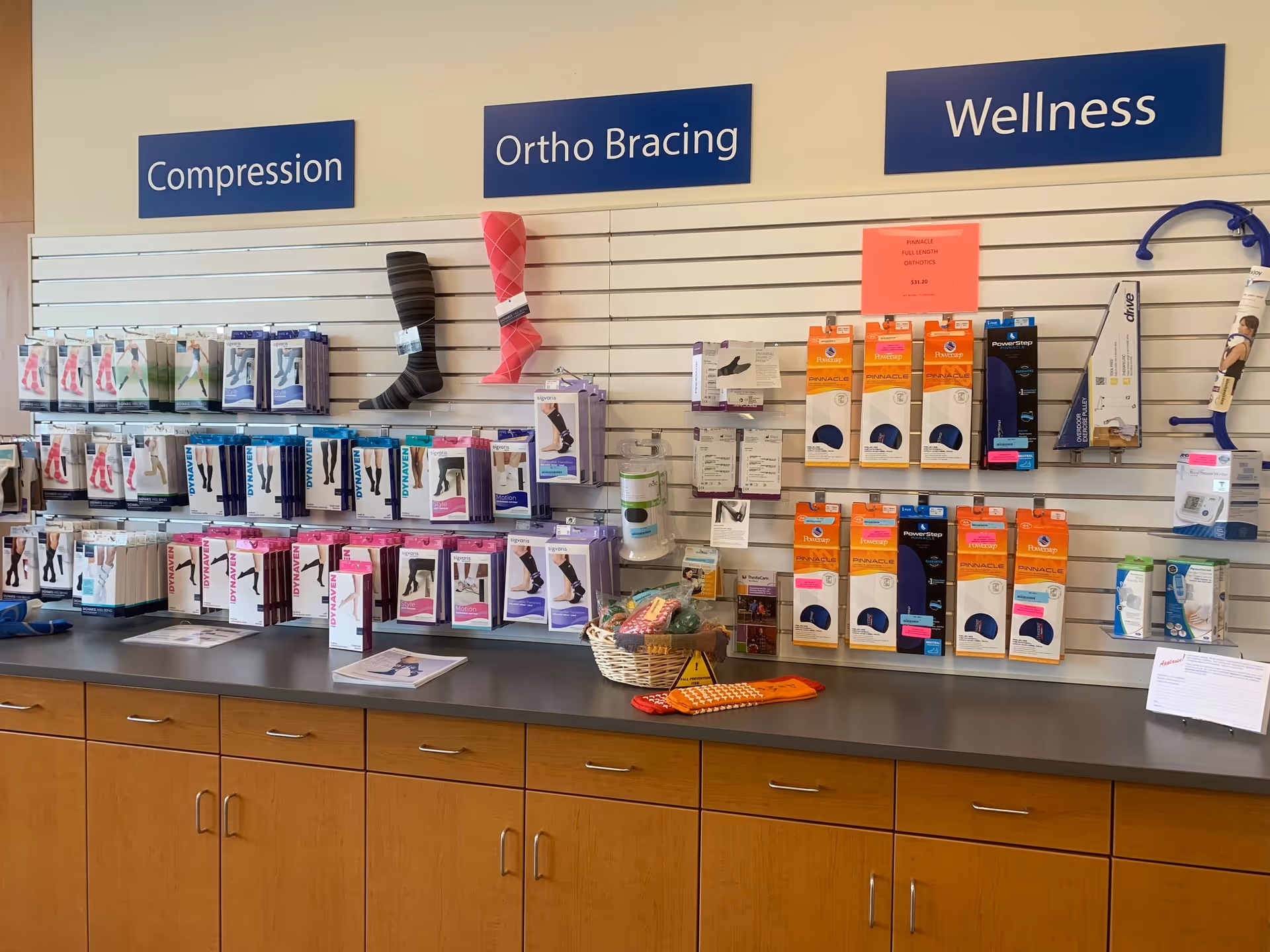 Well-lit interior display wall featuring compression stockings and orthotics.