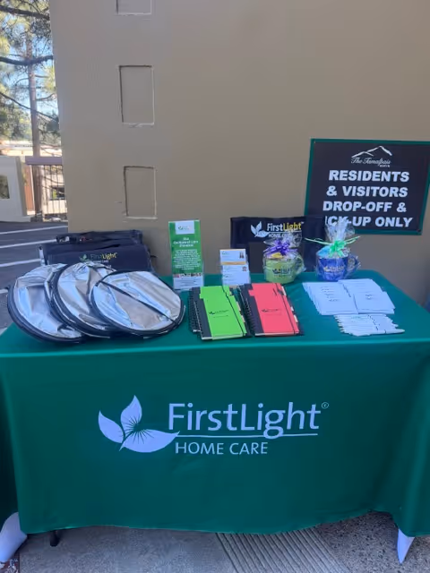 Outdoor display table for FirstLight Home Care outside the building entrance.