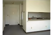 Empty interior hallway in a senior housing facility with a kitchen pass-through.
