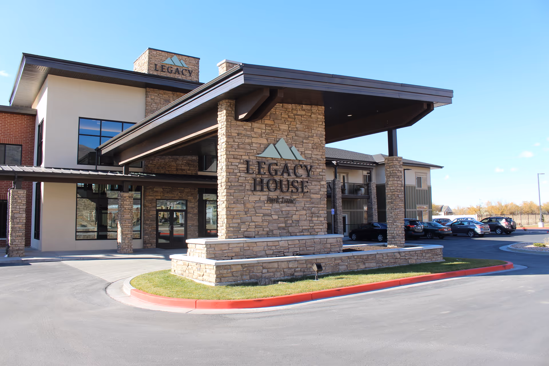 Exterior view of Legacy House of Park Lane with stone facade and parking