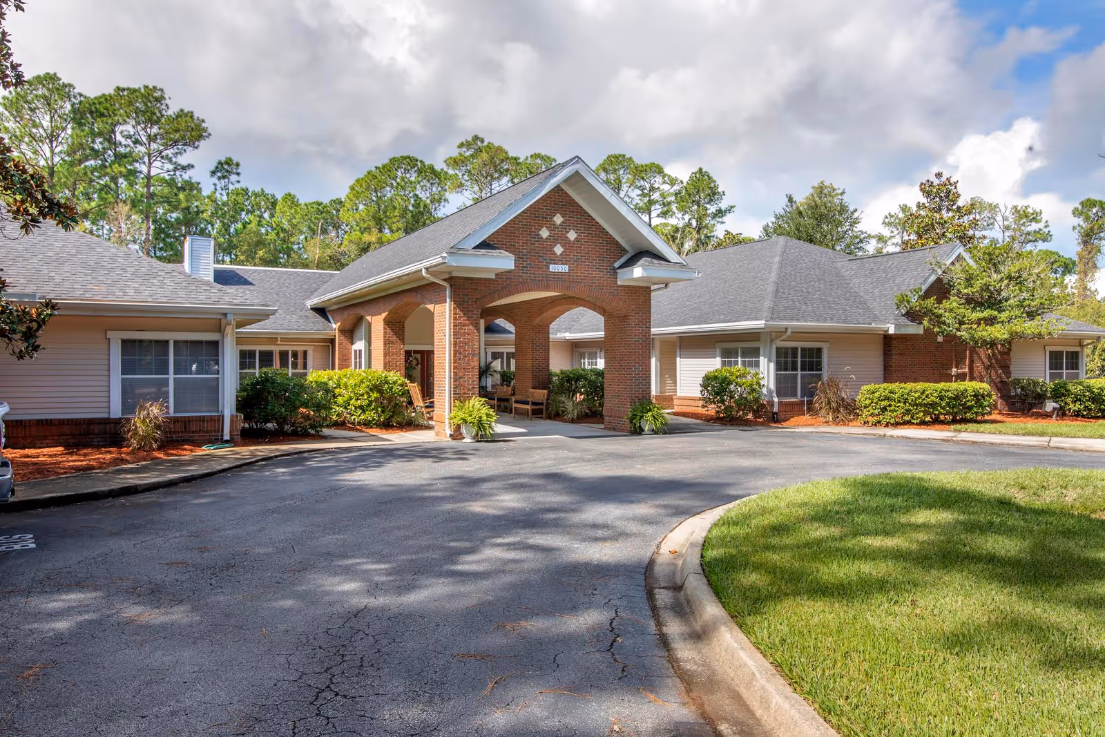 Brookdale Crown Point facility exterior with brick entrance, covered walkway, and surrounding landscaping.
