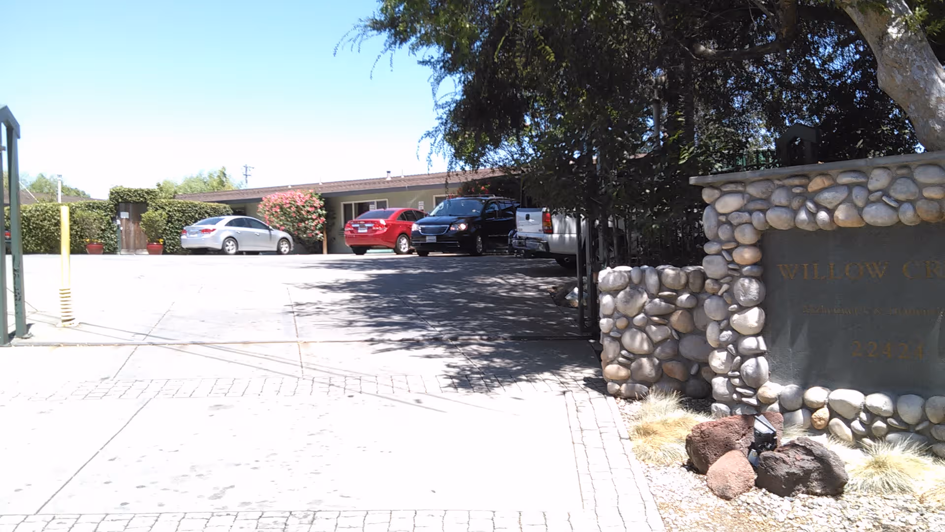 Exterior view showing a stone sign and gated entrance at Willow Creek parking area.