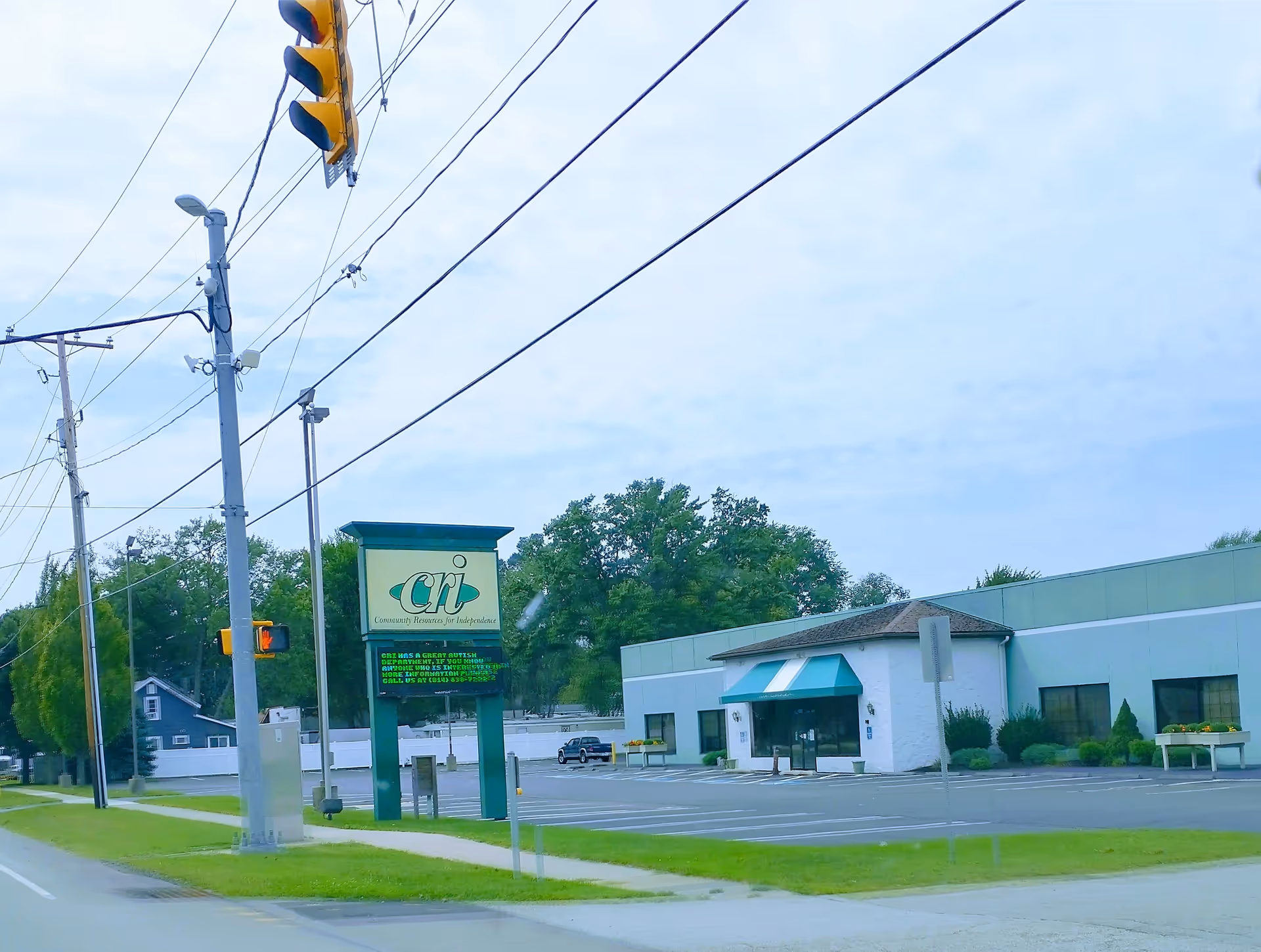Exterior view of Community Resources for Independence in Erie, PA, with sign and parking.