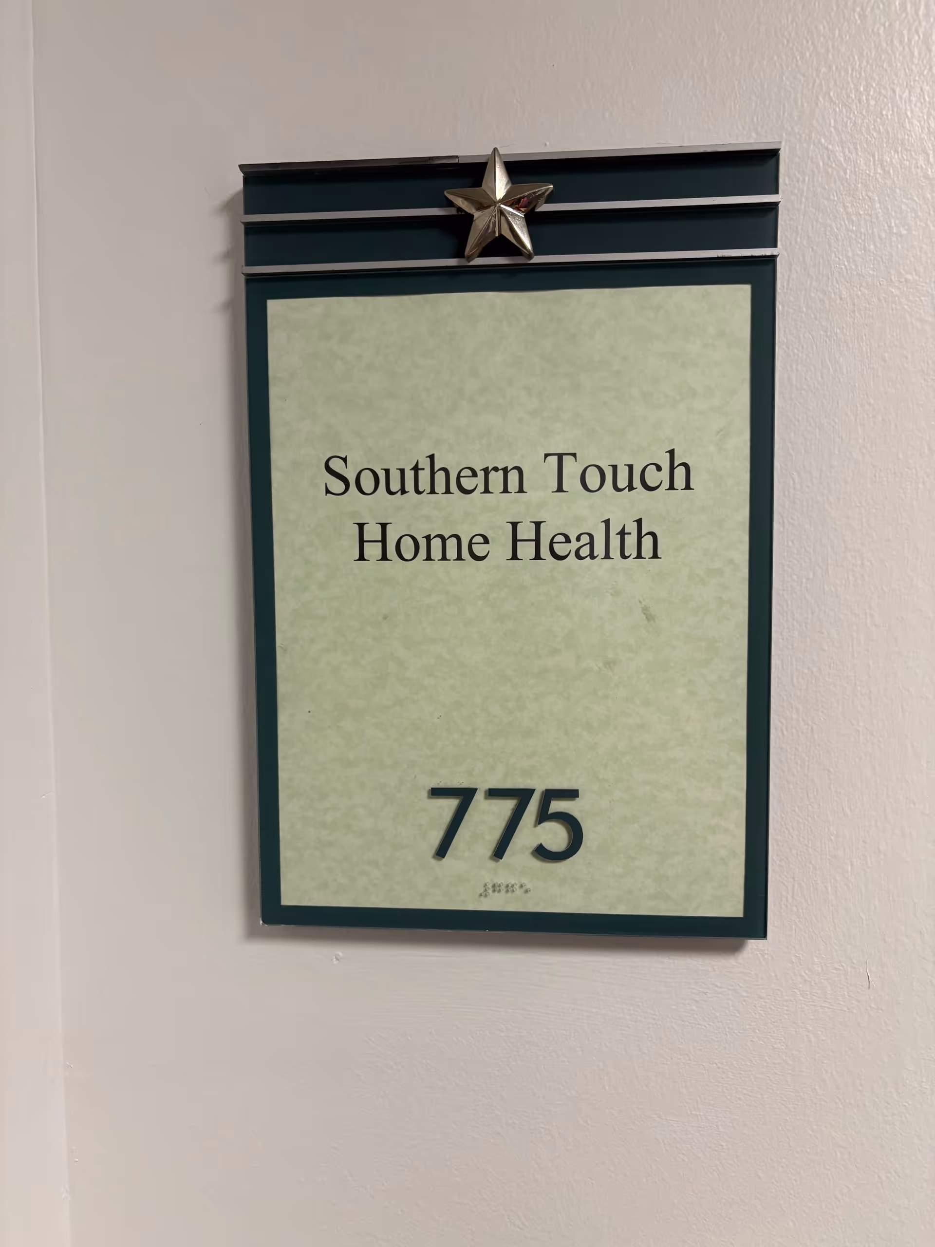 Interior wall sign shows Southern Touch Home Health and the number 775.