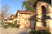 Exterior view of Leisure Village in Camarillo with tan stucco buildings and landscaping.
