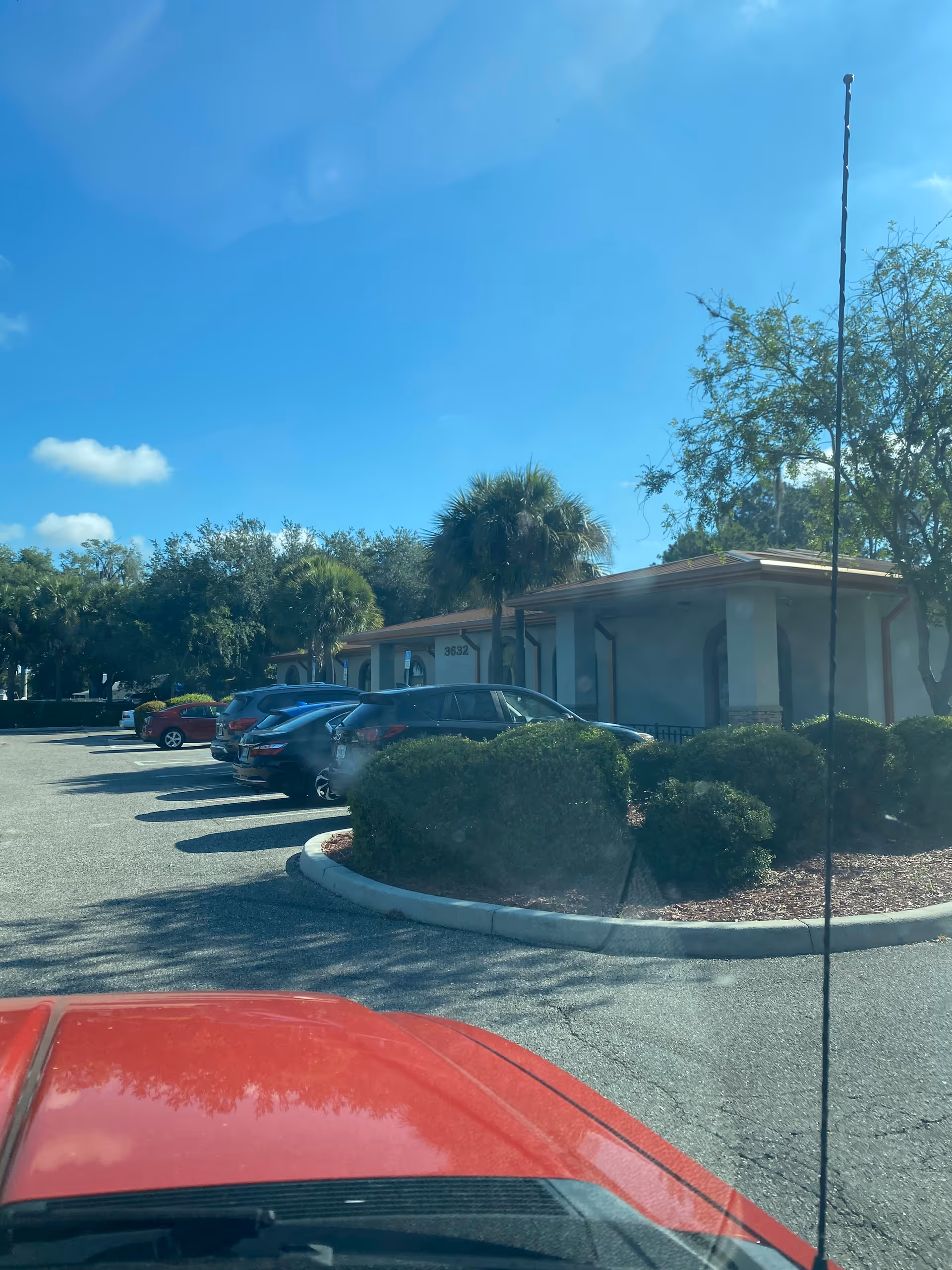 Exterior view of Homecare Team facility with parked cars and landscaping.