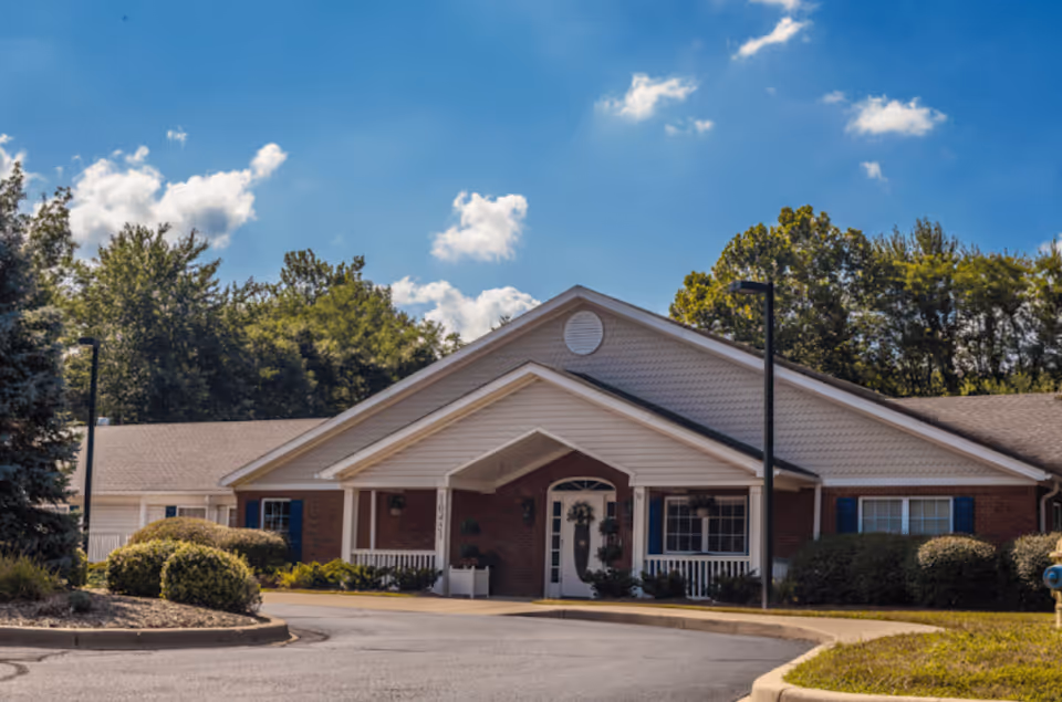 Front view of The Pinnacle of Louisville entrance with brick exterior and surrounding landscaping.