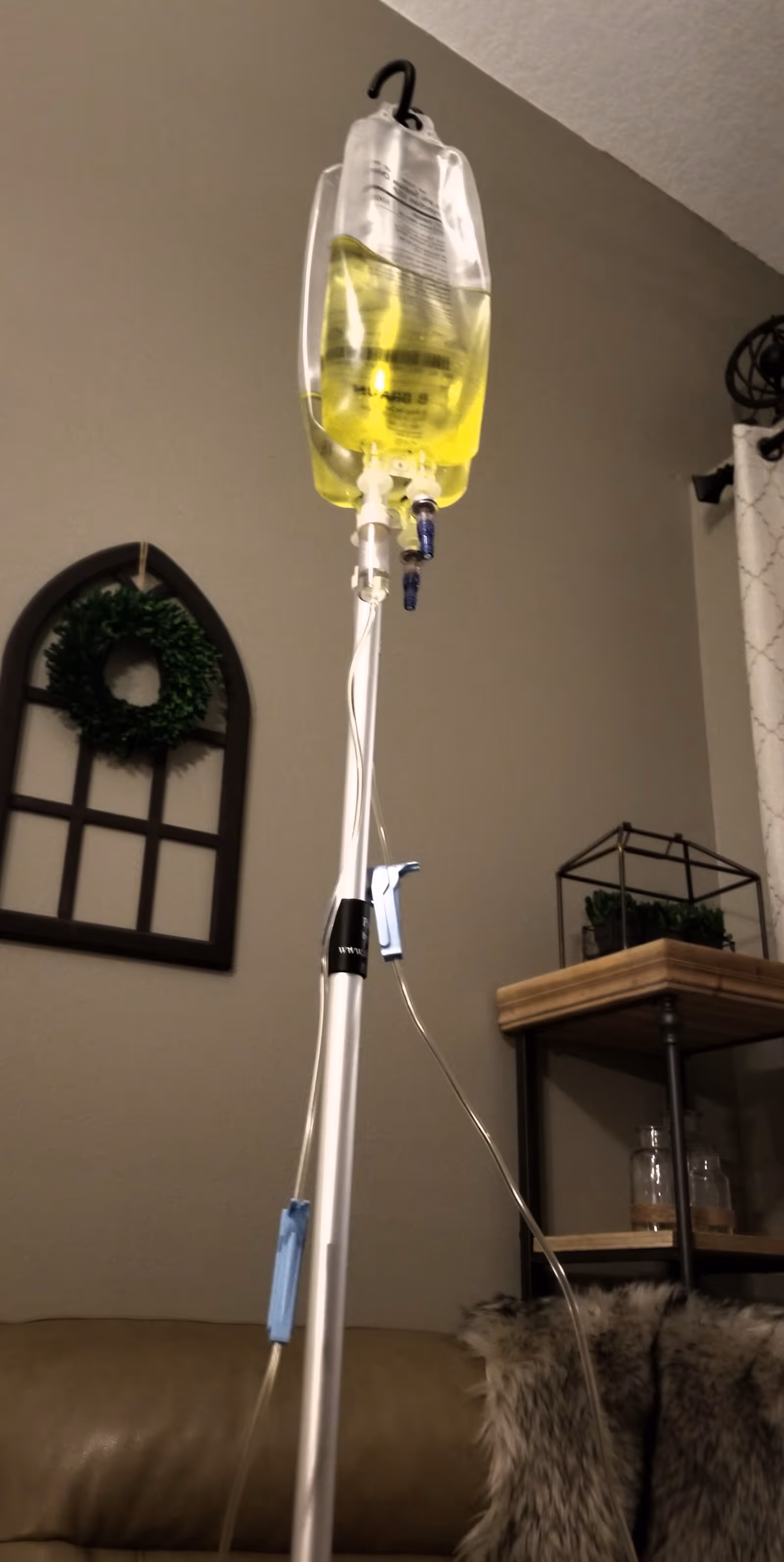 IV bag on a stand in a cozy living room at a senior facility.