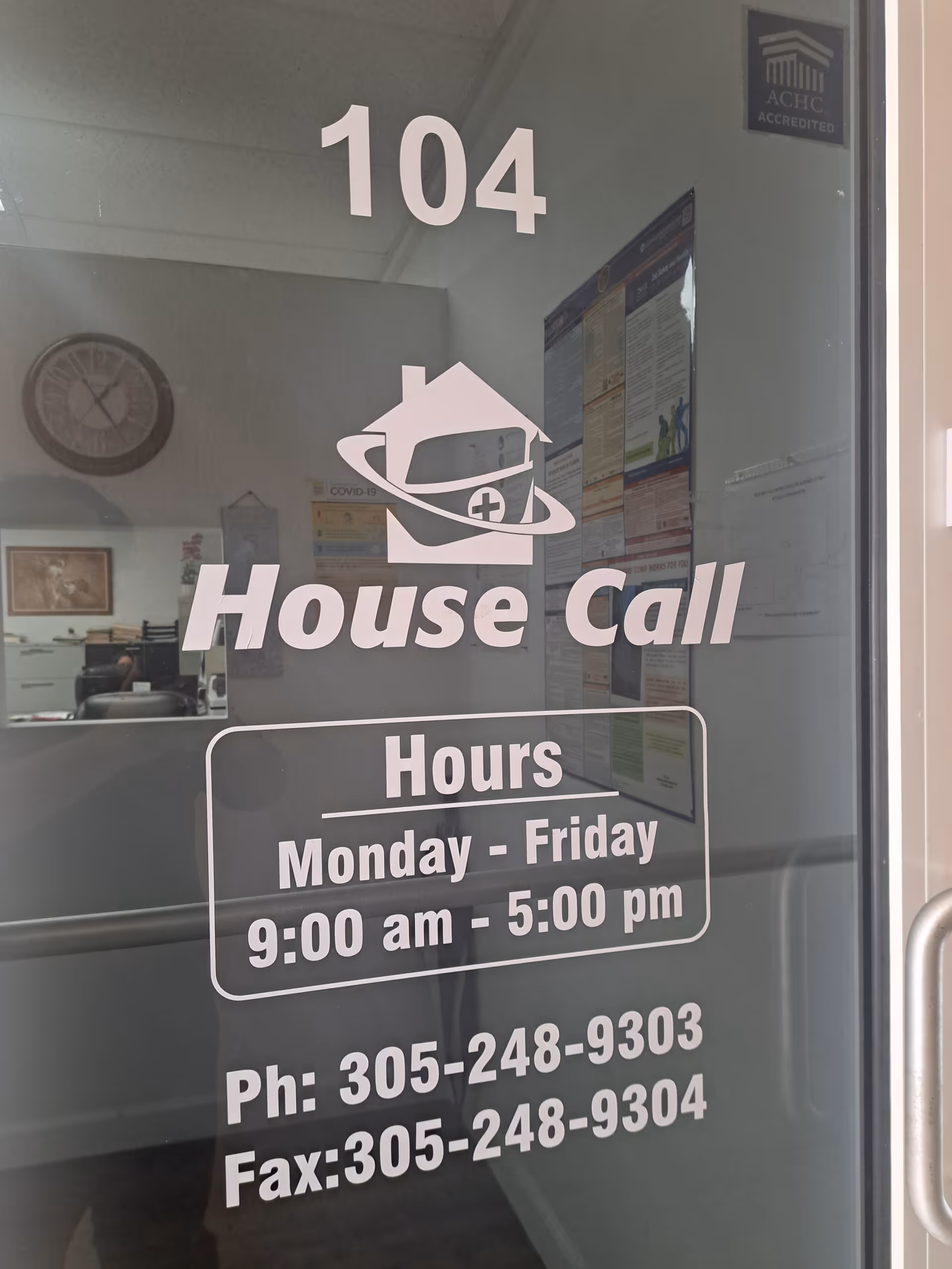 Glass door displays House Call logo, hours, and phone numbers inside an office.