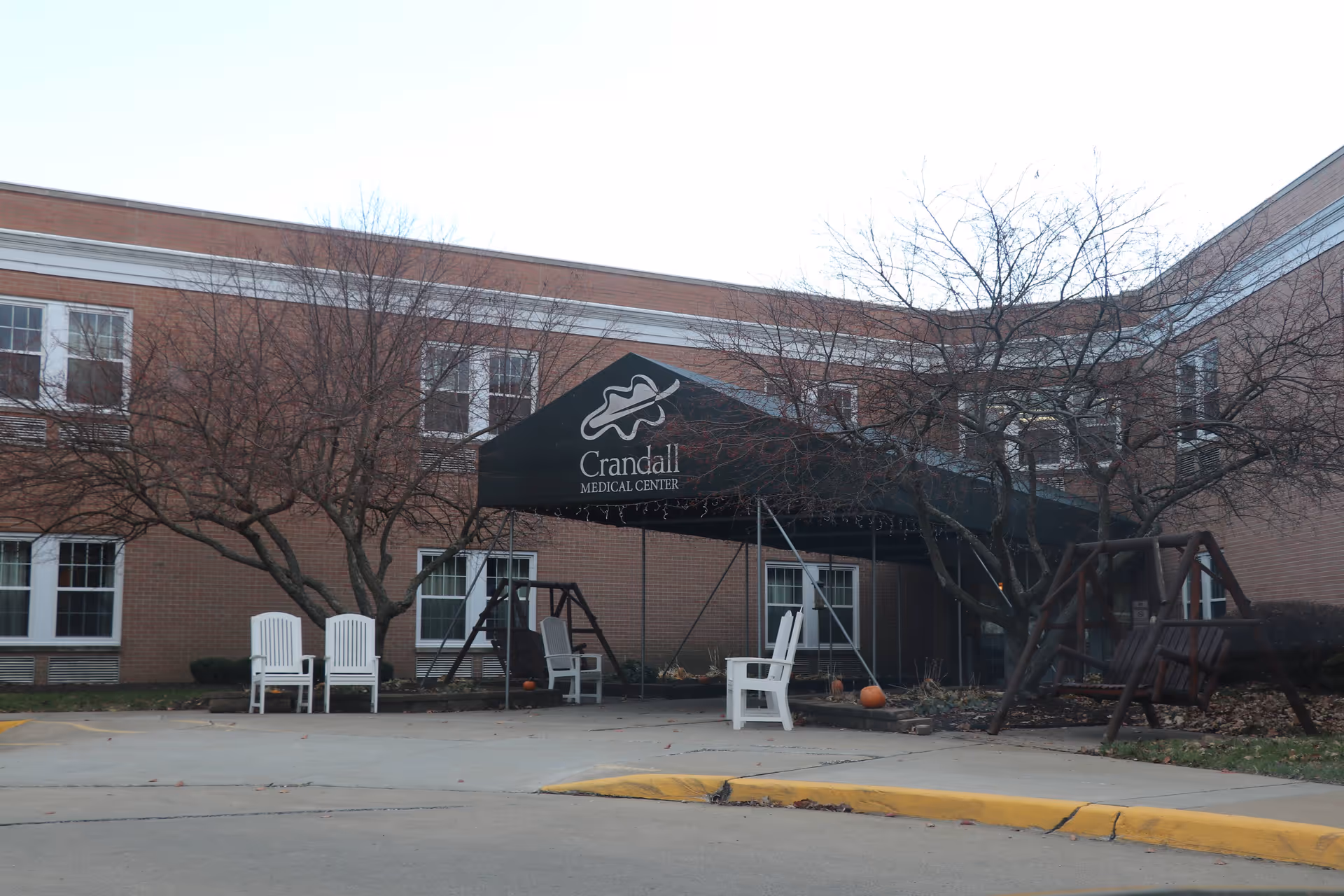 Exterior view of a brick building with a black canopy entrance labeled Crandall Medical Center.