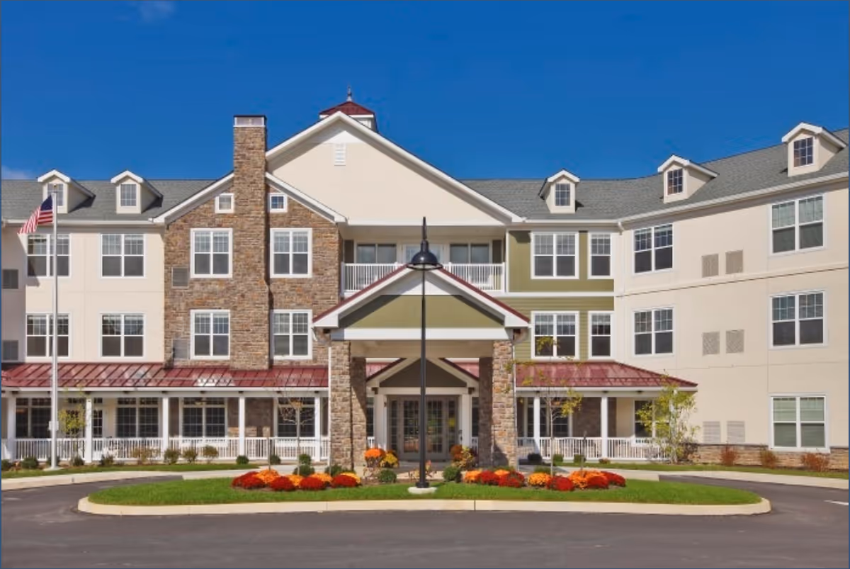 Exterior view of Arbor Terrace Willistown, a multi-story senior living building with landscaped entrance.