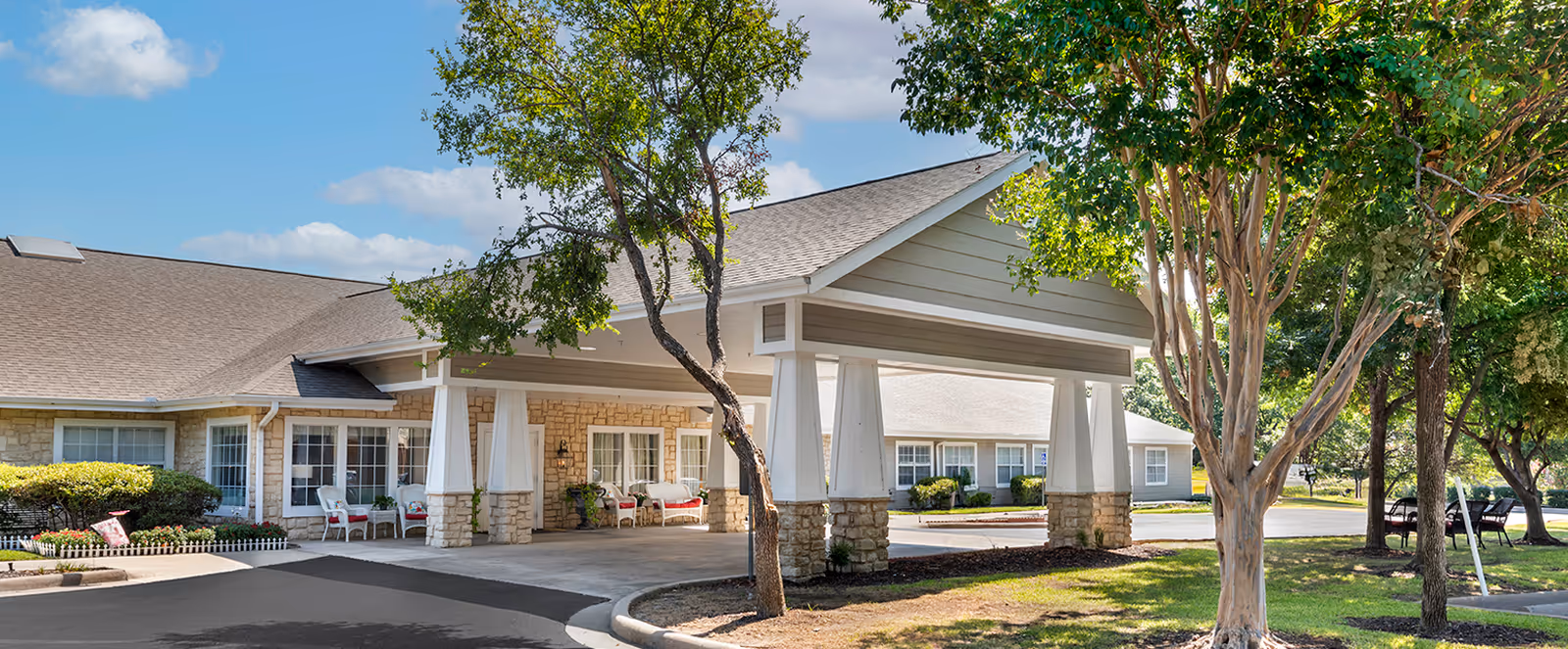 Brookdale White Rock exterior with covered entrance and trees.