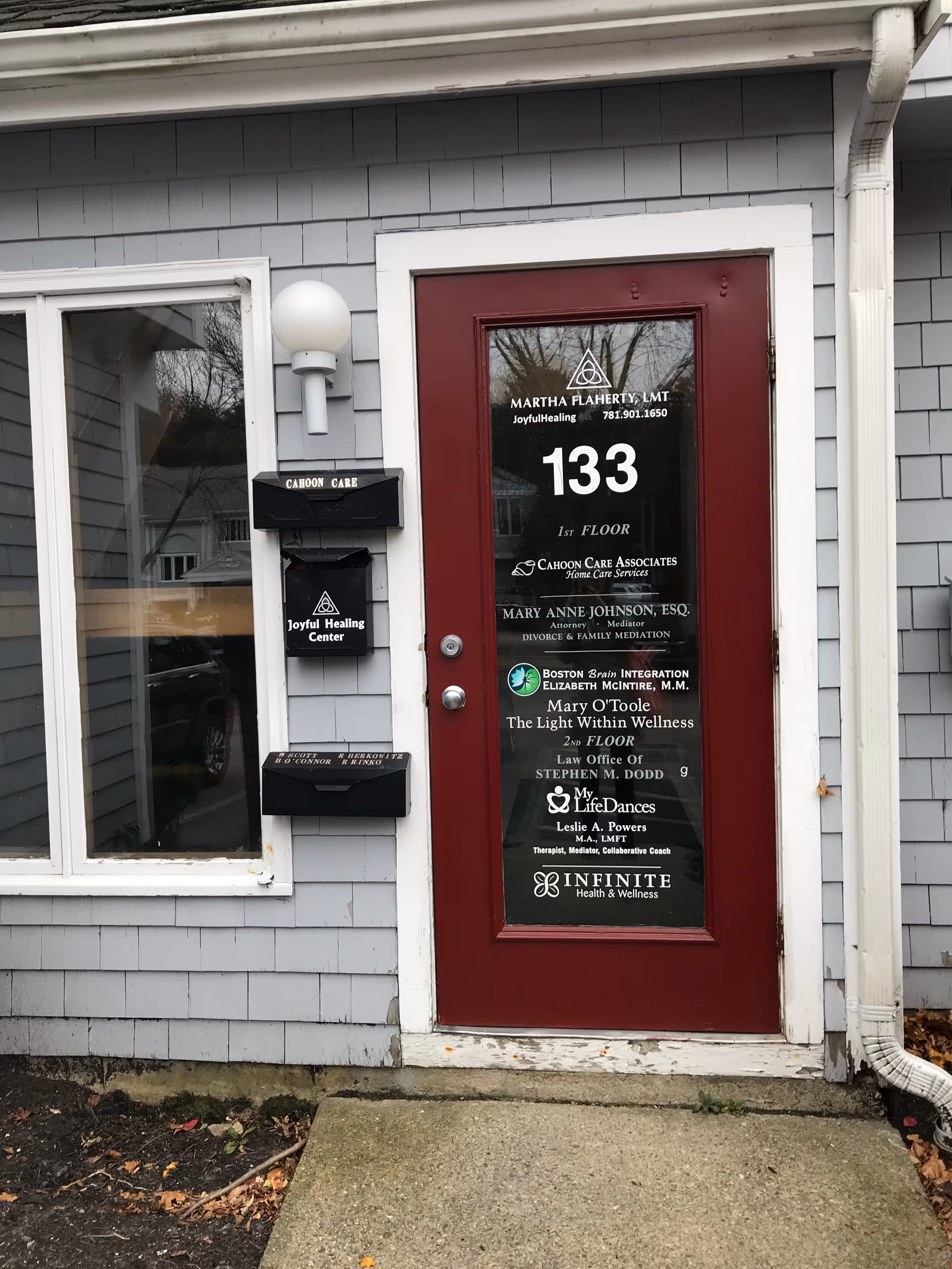 A gray exterior wall features a maroon door labeled 133 and Cahoon Care signage.