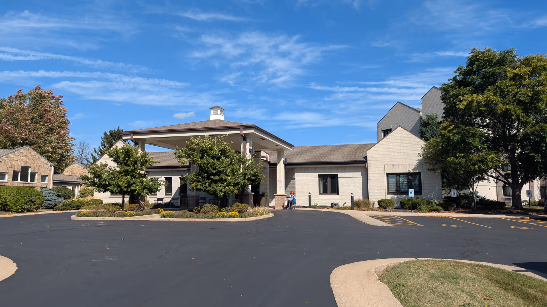 Exterior view of Harbour House facility with a covered entrance and landscaping.