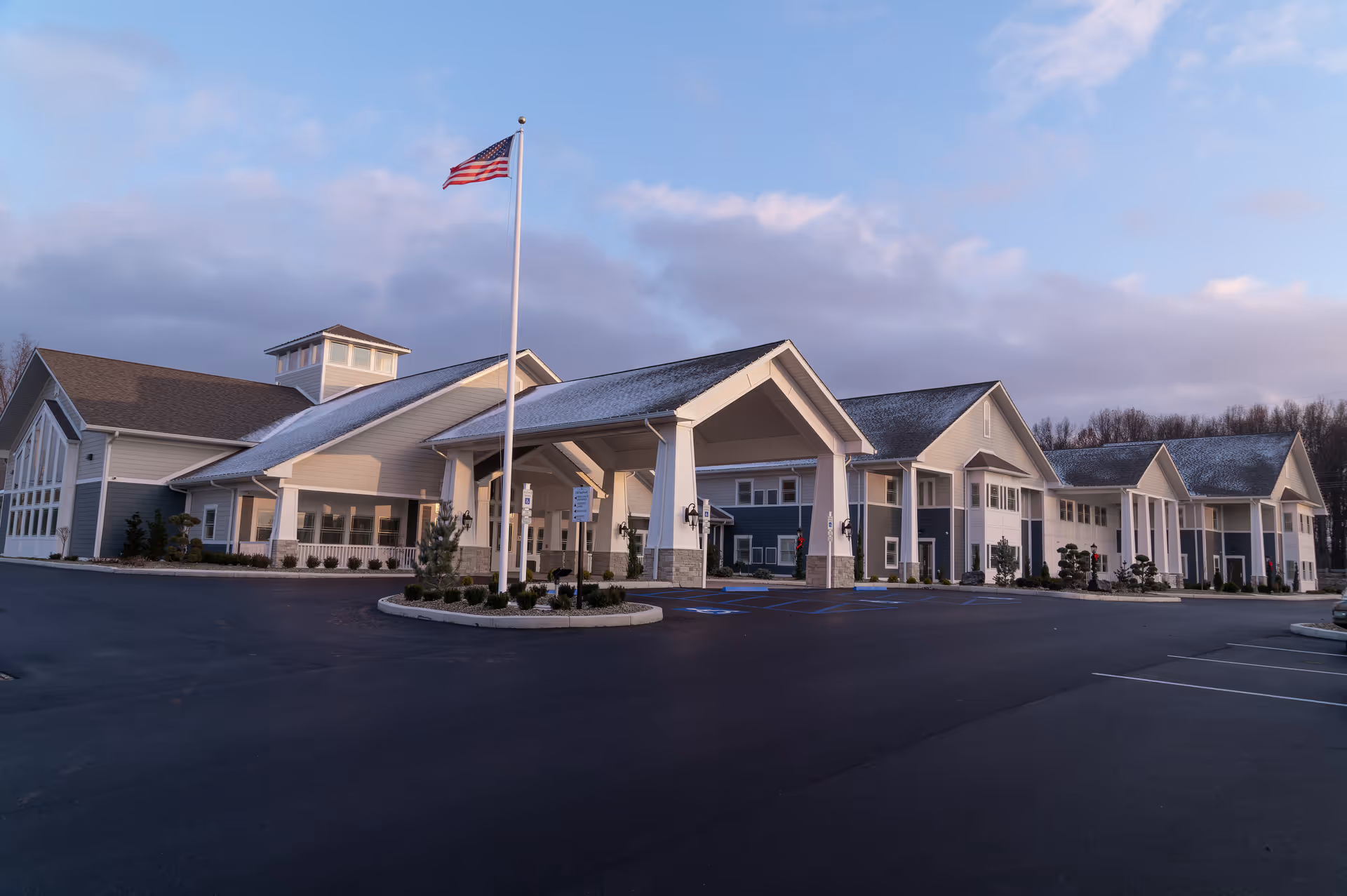 The Inn at Old Saybrook exterior shows a modern, long front entrance with an American flag.