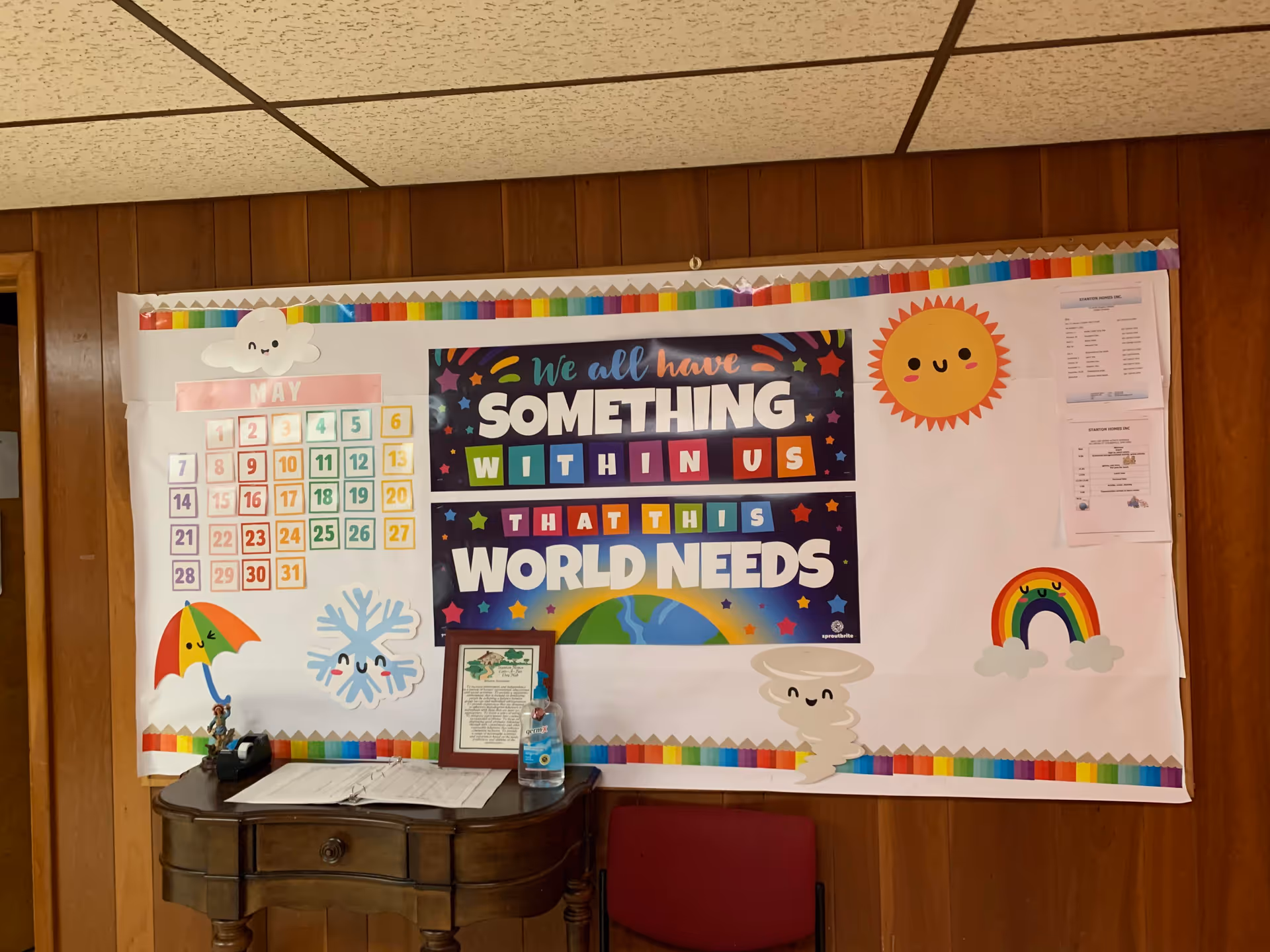 Interior wall features a colorful inspirational banner with cheerful graphics.