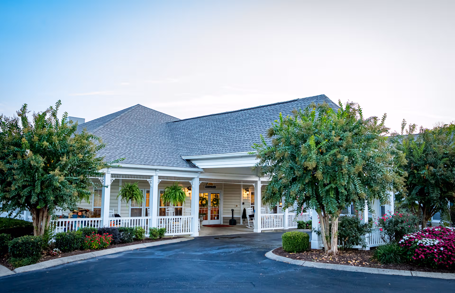 Front view of Charter Senior Living of Gallatin with a welcoming porch and landscaping.