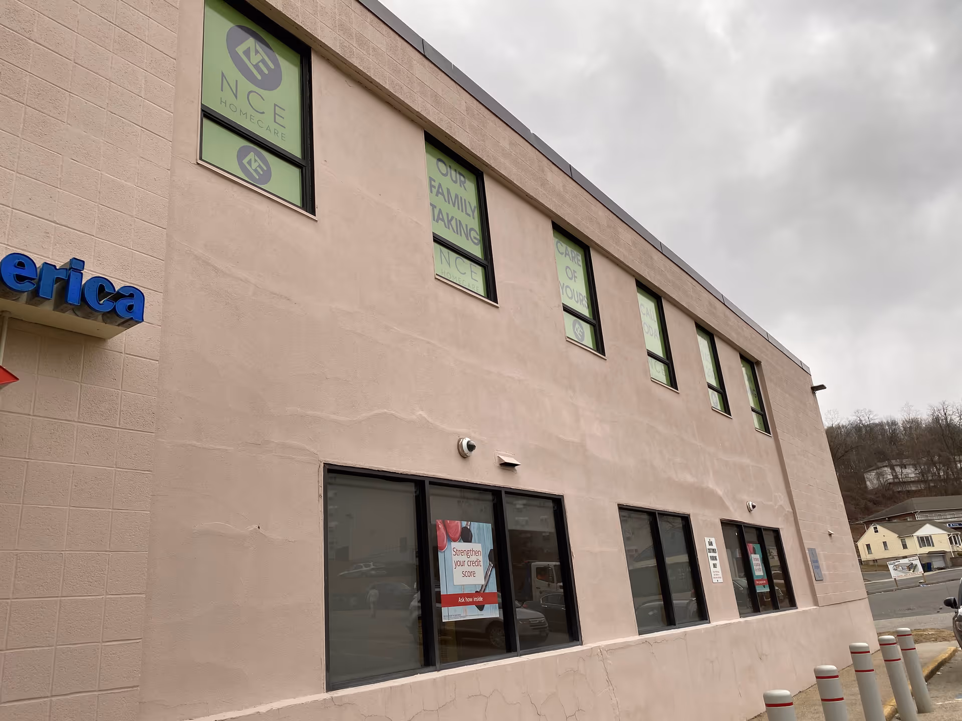 Beige facility building with NCE Homecare signage and large windows along the front.