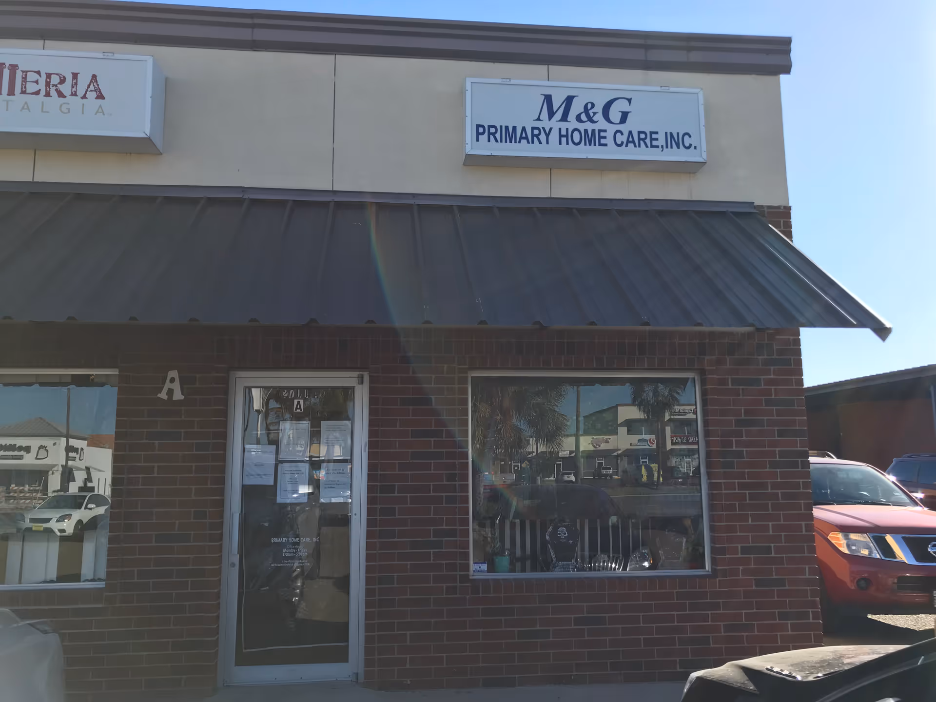 Brick storefront displays M&G Primary Home Care sign on exterior facade.