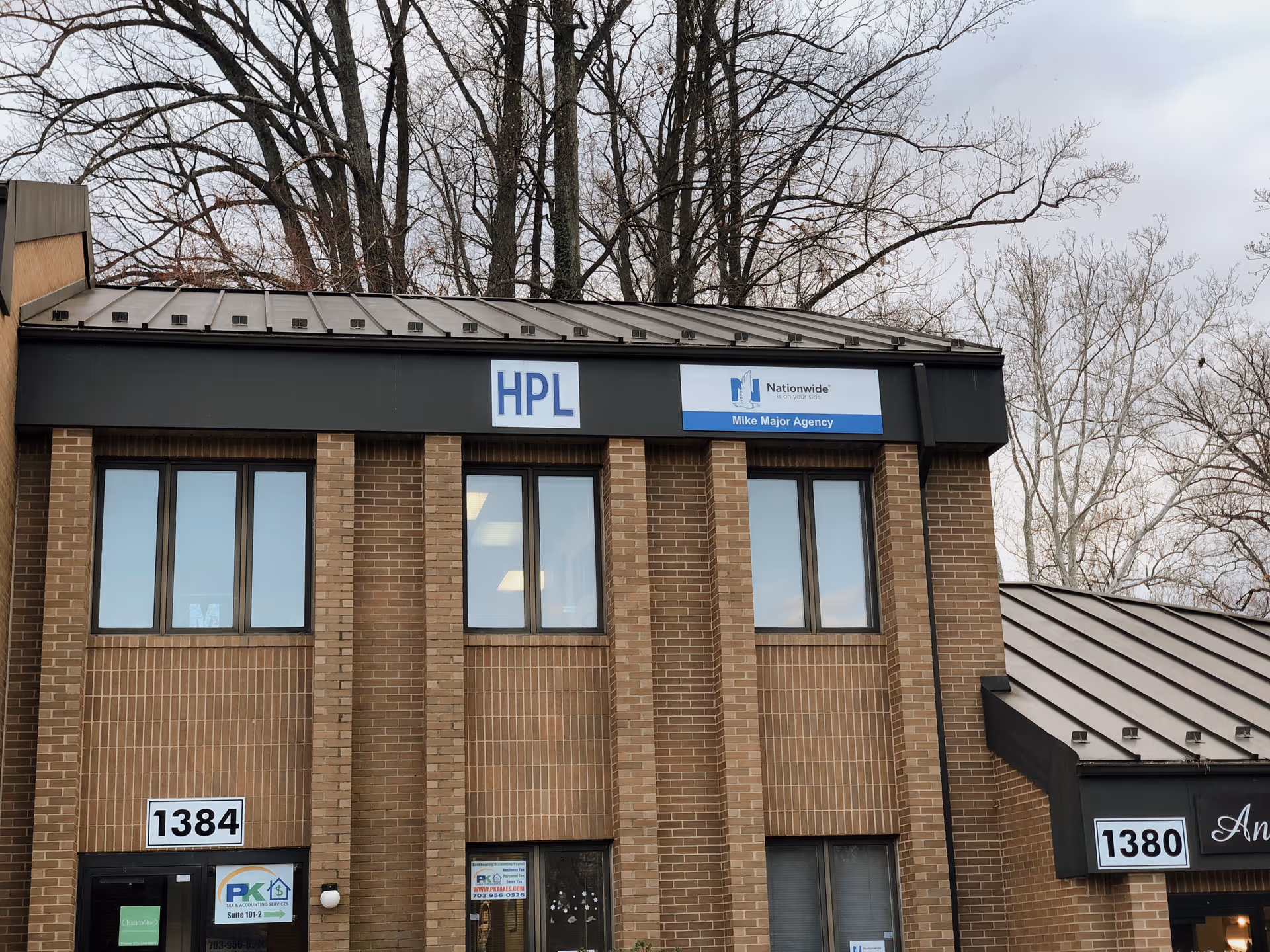 Exterior view of a brick building with HPL and Nationwide signs for senior care.